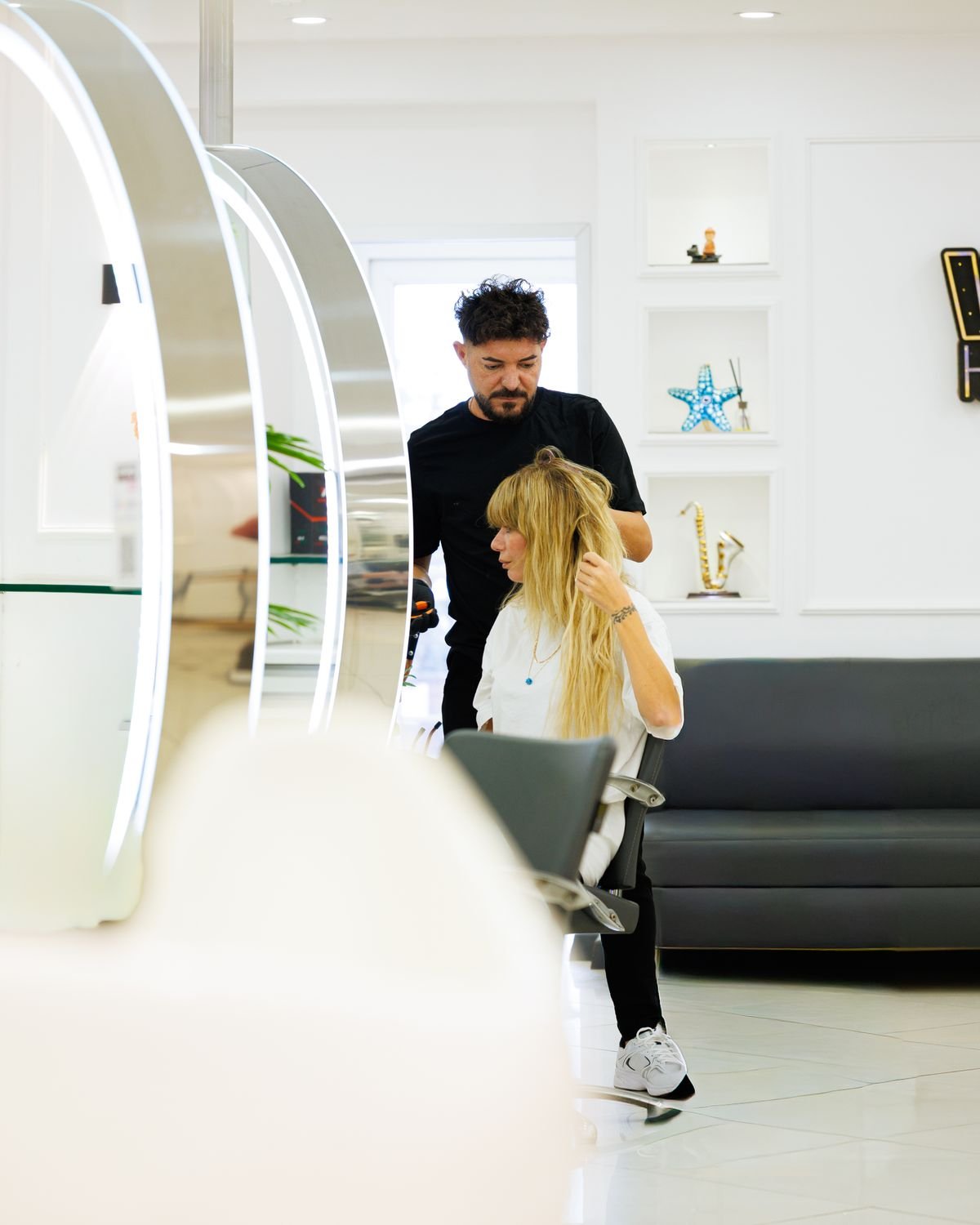 Stylist working through a client's hair at the salon